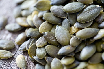 pumpkin seeds on wooden surface