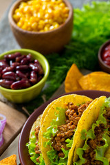 plate of tacos, nachos and tomato dip
