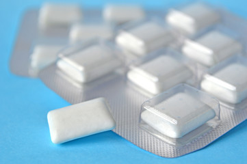 White chewing gum on blue background