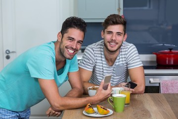 Portrait of male friends using phone 