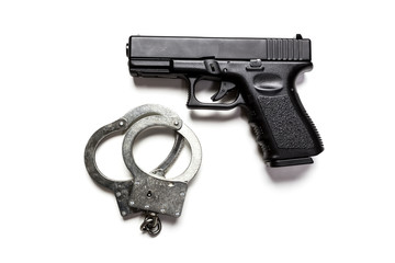 gun and handcuffs on white background