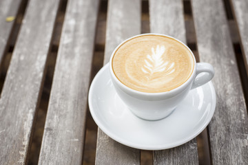 cappuccino cup on wood background