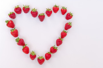 Heart shaped strawberries on white background strawberry heart