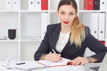 Beautiful businesswoman make notes sitting at office. Business, exchange market, job offer,...