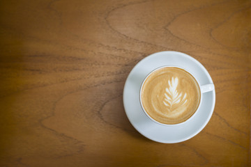 cappuccino cup on wood background