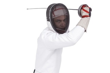 Man wearing fencing suit practicing with sword