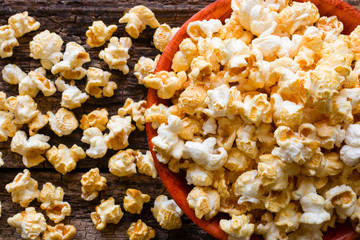 popcorn with caramel on a wooden background close up
