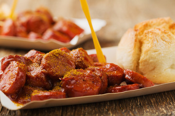 Traditional German currywurst, served on disposable paper tray w