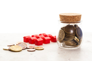 Mortgage concept by model house with coins