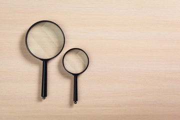 magnifying glass on the wooden background