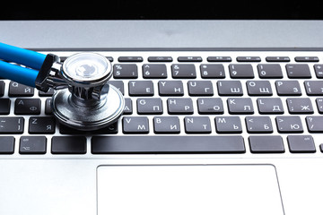 Medical stethoscope on computer keyboard