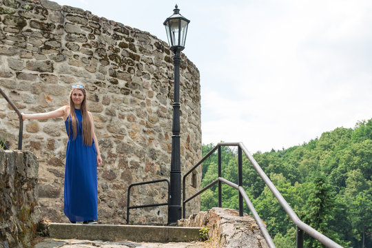 Young girl on background of old wall and lanp