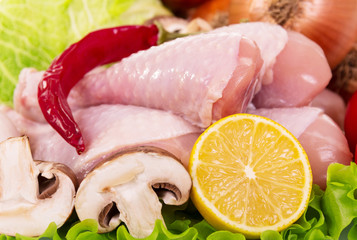 Raw chicken legs and ingredients for cooking meals.