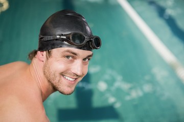 Portrait of happy swimmer about to dive into the pool