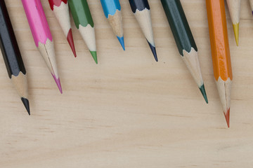 Obraz premium pencils color on wood table.