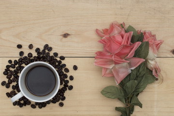 Obraz na płótnie Canvas coffee and flowers on wood table.