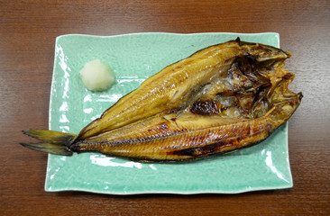 Japanese cuisine, grilled shima hokke fish on green ceramic squa