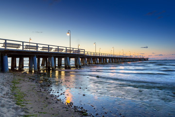 Obraz premium Baltic sea with pier in Gdynia Orlowo at sunrise, Poland