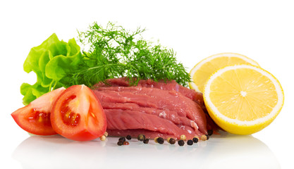 Fresh beef, herbs, tomatoes, lemon and spices isolated on white.