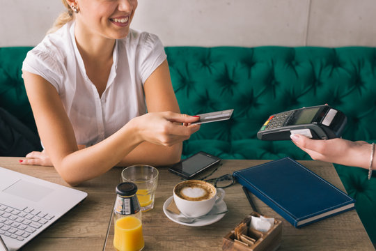 Woman Pay With Credit Card In Cafe Bar