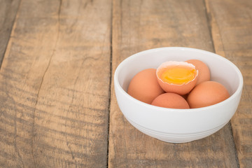 Fresh farm eggs. A egg yolk in cracked egg shell.