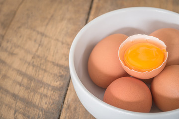 Fresh farm eggs. A egg yolk in cracked egg shell.