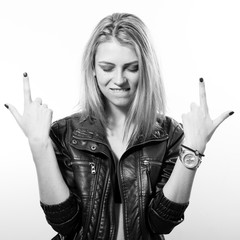 fashion rock star: black and white portrait of sexy young blonde woman in leather jacket posing...
