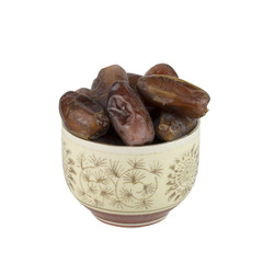 dried dates in the bowl on white background