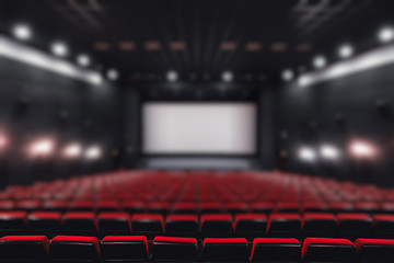 Abstract blur Empty rows of red theater or movie seats. Chairs in cinema hall. Comfortable armchair