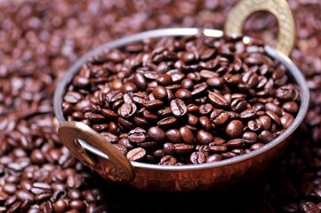 Coffee beans in a copper plate