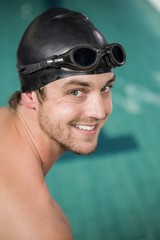 Portrait of happy swimmer about to dive into the pool