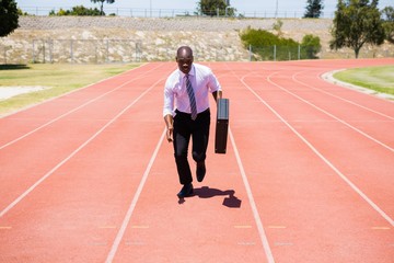 Businessman running on a running track