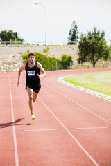 Fototapeta premium Athlete running on the racing track