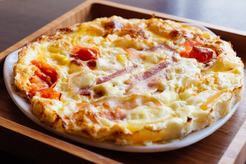 Scrambled eggs with bacon and tomato. Bon Appetit
