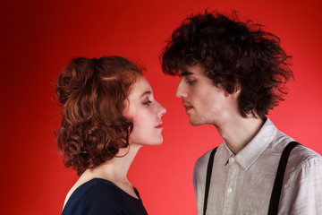 Portrait of a beautiful young couple love romance red background