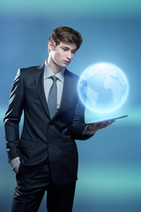 Young businessman with touch screen computer