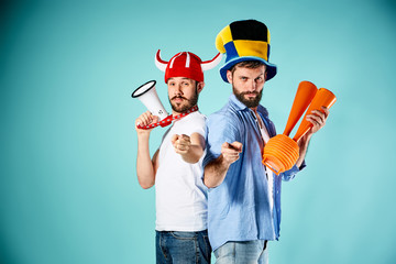 The two football fans with mouthpiece over blue