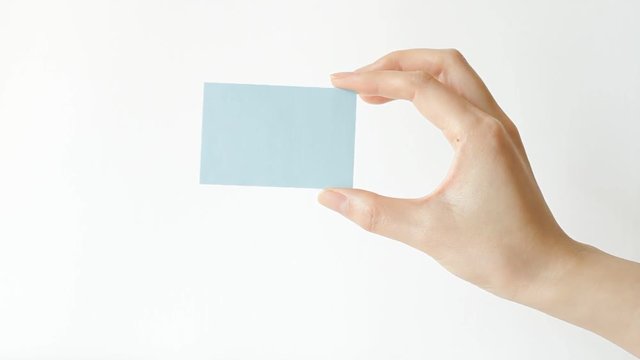 Hand holding and moving blue blank card 