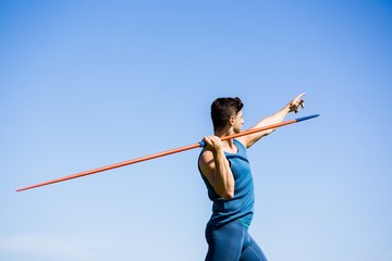 Athlete about to throw a javelin - Powered by Adobe