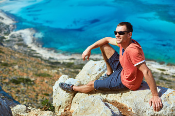 man reluxing on the rock