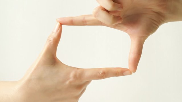 Hands making picture frame 