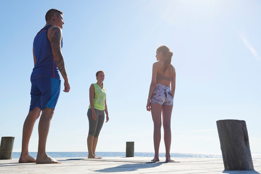 Fiends wearing sports clothes standing on pier