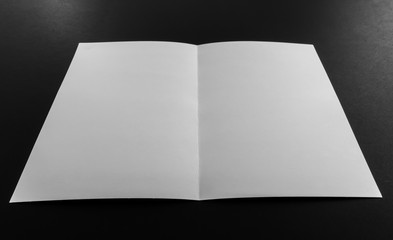 Bifold white template paper on black background .