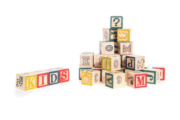 photo of a alphabet blocks spelling kids isolate on white backgr