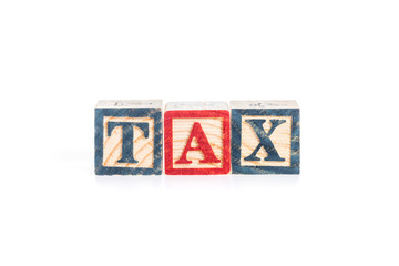 photo of a alphabet blocks spelling TAX isolate on white backgro