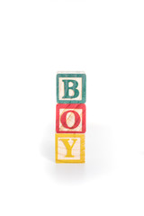 photo of a alphabet blocks spelling BOY isolate on white backgro