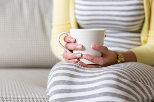 female hands holding cup