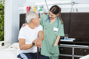 Patient And Nurse Looking At Each Other In Rehab Center