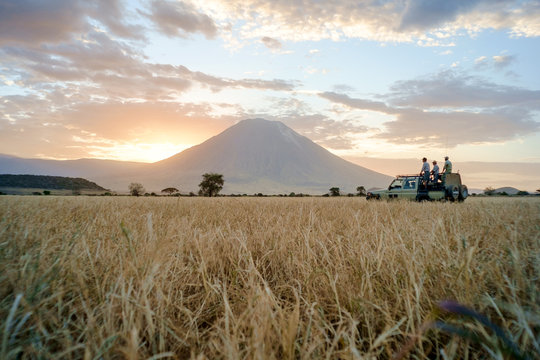 Fototapeta People on safari in savannah landscape during sunset, Africa