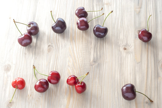 cherries scattered on aged wood
